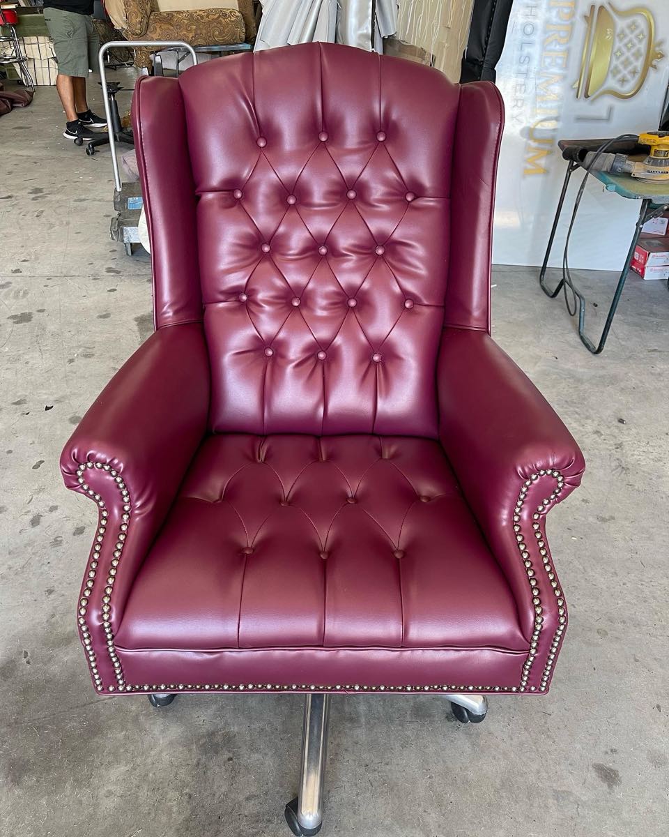 Burgundy tufted leather wingback chair reupholstered by One Premium Upholstery